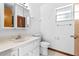 Bright bathroom featuring a vanity, toilet, medicine cabinet, and window at 3104 Umbrella Tree Dr, Edgewater, FL 32141