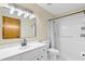 Bathroom with white vanity, toilet, shower with curtain, and rectangular mirror with globe lighting at 3104 Umbrella Tree Dr, Edgewater, FL 32141