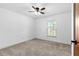 Bedroom with light carpet, a ceiling fan, and a window letting in natural light at 3104 Umbrella Tree Dr, Edgewater, FL 32141