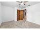 Bedroom with light carpet, a closet with wood doors, and a doorway leading to another room at 3104 Umbrella Tree Dr, Edgewater, FL 32141