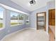 Bright breakfast nook features tile flooring, large windows, and laundry room access at 3104 Umbrella Tree Dr, Edgewater, FL 32141