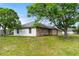 Side view of brick home showing a stucco addition and a well-maintained lawn at 3104 Umbrella Tree Dr, Edgewater, FL 32141