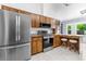 Eat-in kitchen features stainless appliances and a breakfast bar at 3104 Umbrella Tree Dr, Edgewater, FL 32141