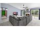 Cozy living room with a fireplace, large sectional couch, and sliding doors at 3104 Umbrella Tree Dr, Edgewater, FL 32141