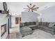 Bright living room with a brick fireplace, large sectional sofa and neutral decor at 3104 Umbrella Tree Dr, Edgewater, FL 32141