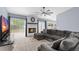 Comfortable living room features a white brick fireplace, sectional sofa, and natural light at 3104 Umbrella Tree Dr, Edgewater, FL 32141