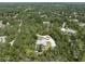 Aerial view of home featuring lush greenery and circular driveway at 3211 Hidden Crest Ln, Deland, FL 32724