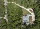 Aerial view of home featuring a pool, long driveway, and lush greenery at 3211 Hidden Crest Ln, Deland, FL 32724
