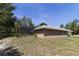 Home exterior with a screened-in patio and expansive green yard at 3211 Hidden Crest Ln, Deland, FL 32724