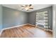 Well-lit bedroom with wood-look floors and a window with light filtering at 3211 Hidden Crest Ln, Deland, FL 32724