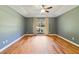 A spacious and empty bedroom featuring neutral wall colors, hardwood floors, and a large window at 3211 Hidden Crest Ln, Deland, FL 32724