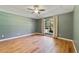 The empty bedroom features a large window, hardwood floors, and neutral wall colors at 3211 Hidden Crest Ln, Deland, FL 32724
