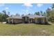 Charming brick home with manicured lawn and mature trees offers a welcoming curb appeal at 3211 Hidden Crest Ln, Deland, FL 32724