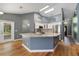 Open concept kitchen with island, granite countertops, stainless appliances, and hardwood floors at 3211 Hidden Crest Ln, Deland, FL 32724