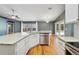 Bright kitchen features granite countertops, stainless steel appliances, white cabinetry and wood flooring at 3211 Hidden Crest Ln, Deland, FL 32724
