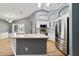 Modern kitchen featuring stainless steel appliances, white cabinets, and a granite island at 3211 Hidden Crest Ln, Deland, FL 32724