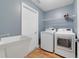 Clean laundry room with modern washer and dryer units at 3211 Hidden Crest Ln, Deland, FL 32724