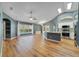 Open-concept living space with hardwood floors, skylights and a seamless flow to the kitchen at 3211 Hidden Crest Ln, Deland, FL 32724