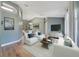 Living room with white sofas, glass table, large TV, and a neutral color palette at 3211 Hidden Crest Ln, Deland, FL 32724