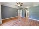 Spacious main bedroom featuring wood floors, a ceiling fan, and neutral paint at 3211 Hidden Crest Ln, Deland, FL 32724