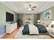 Well-lit main bedroom with a queen sized bed, white dresser, and large window at 3211 Hidden Crest Ln, Deland, FL 32724