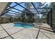 Backyard screened-in pool, lush greenery and outdoor seating area at 3211 Hidden Crest Ln, Deland, FL 32724