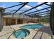 Backyard screened-in pool and hot tub with lush landscaping at 3211 Hidden Crest Ln, Deland, FL 32724