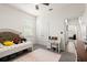 Cozy bedroom with a comfortable bed, stylish rug, and a view into the hallway at 322 E Merimont Ln, Ormond Beach, FL 32174