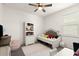 Comfortable bedroom features a charming bed, decorative rug, and ample natural light at 322 E Merimont Ln, Ormond Beach, FL 32174