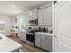 Contemporary kitchen with stainless steel appliances, gray cabinets and a door leading to the backyard at 322 E Merimont Ln, Ormond Beach, FL 32174