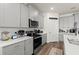 Modern kitchen featuring stainless steel appliances, gray cabinets and countertops and a subway tile backsplash at 322 E Merimont Ln, Ormond Beach, FL 32174