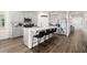 Modern kitchen with sleek gray cabinetry, stainless steel appliances, and a spacious island with bar seating at 322 E Merimont Ln, Ormond Beach, FL 32174