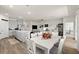 Open-concept living space featuring a kitchen island, dining area, and comfortable living room setup at 322 E Merimont Ln, Ormond Beach, FL 32174