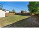 Spacious backyard with a lush green lawn and a tall wooden fence for privacy at 3237 Cranston St, Deltona, FL 32738