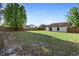 Expansive fenced backyard with lush green grass and trees providing shade at 3237 Cranston St, Deltona, FL 32738