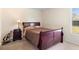 Cozy bedroom with a wood sleigh bed frame and a view of the fenced-in backyard at 3237 Cranston St, Deltona, FL 32738