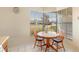 Charming breakfast nook with a round wooden table and bright natural light from large window at 3237 Cranston St, Deltona, FL 32738