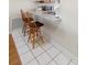 Kitchenette featuring tile floor and counter seating with two wooden chairs at 3237 Cranston St, Deltona, FL 32738