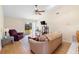 Bright living room with vaulted ceilings, a ceiling fan, and sliding glass doors leading to backyard at 3237 Cranston St, Deltona, FL 32738