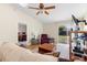 Cozy living room featuring vaulted ceilings, a ceiling fan, and a sliding glass door to the backyard at 3237 Cranston St, Deltona, FL 32738
