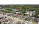 Aerial view showcases the home's location in a quiet neighborhood, close to a wooded area and a small lake at 3845 Arborvitae Way, Deland, FL 32724