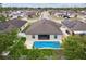 An aerial view shows the home, backyard pool, fence, and surrounding neighborhood at 3845 Arborvitae Way, Deland, FL 32724