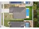 Aerial shot of the property showing the roof, backyard pool, driveway, and surrounding homes at 3845 Arborvitae Way, Deland, FL 32724