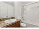 Bathroom with a vanity with a sink, toilet, and shower tub with white tiled walls at 3845 Arborvitae Way, Deland, FL 32724