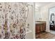 Bathroom featuring a shower with floral curtain, wood-look floors, and granite countertop on wood cabinets at 3845 Arborvitae Way, Deland, FL 32724
