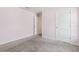Bedroom with carpeted floors, a door, and a window; light bright space at 3845 Arborvitae Way, Deland, FL 32724