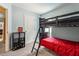 Comfortable bedroom with black bunk beds, a storage unit, and neutral carpeting at 3845 Arborvitae Way, Deland, FL 32724