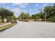 View of the manicured Berry's Ridge community entrance featuring gates, palm trees, and mature landscaping at 3845 Arborvitae Way, Deland, FL 32724