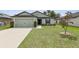 Well-maintained single-Gathering home with an attached two-car garage and a neatly landscaped front yard at 3845 Arborvitae Way, Deland, FL 32724