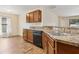 Kitchen area featuring stainless steel sink, granite countertops, and a dishwasher at 3845 Arborvitae Way, Deland, FL 32724